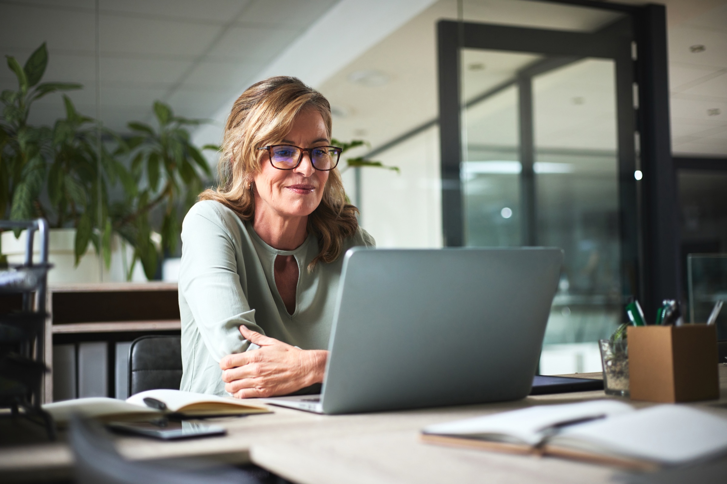 An Information & Referral specialist reviewing resources on a laptop
