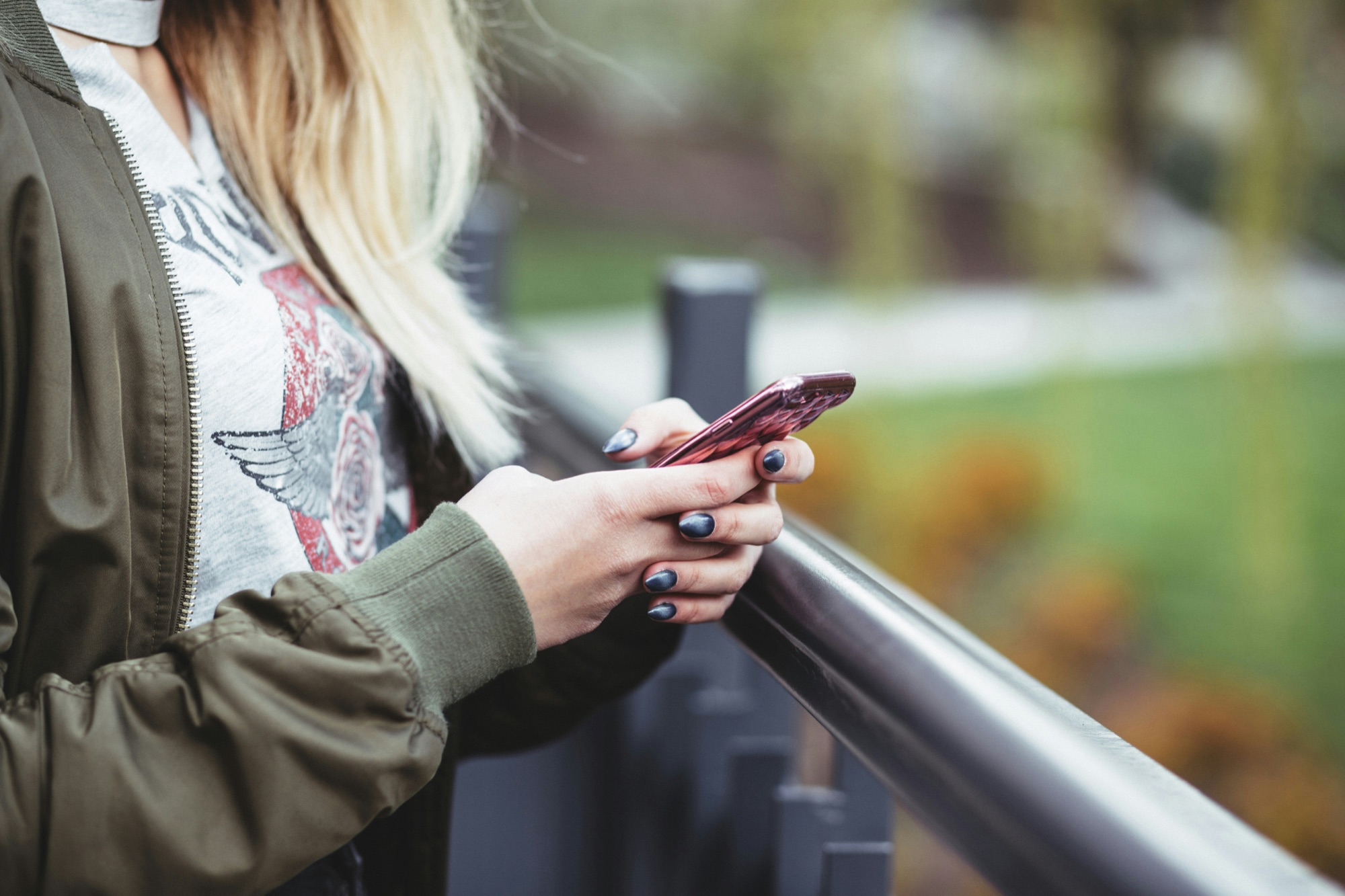 Someone using a phone outdoors to find nearby community resources
