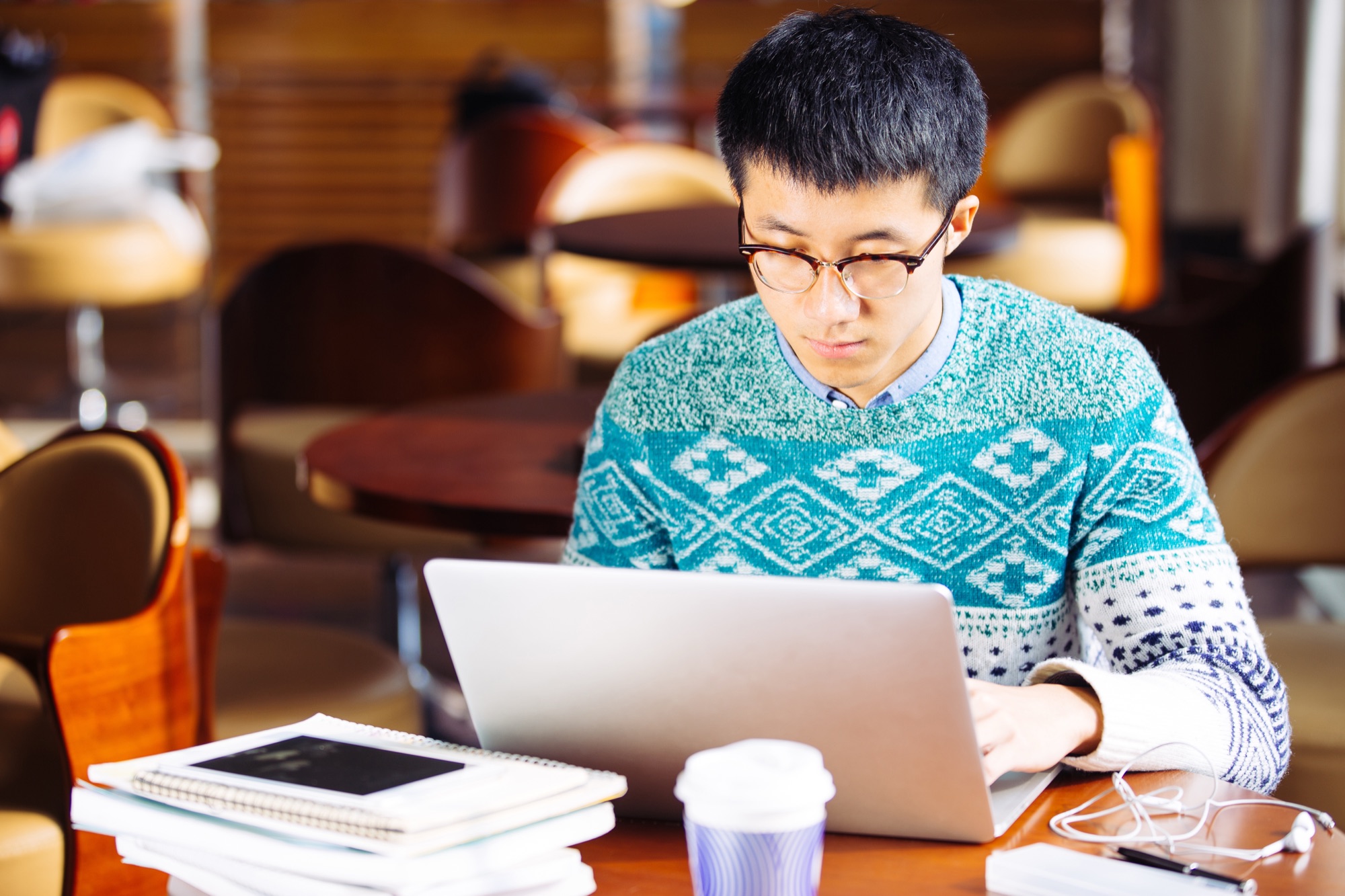 A developer working on a laptop in a café