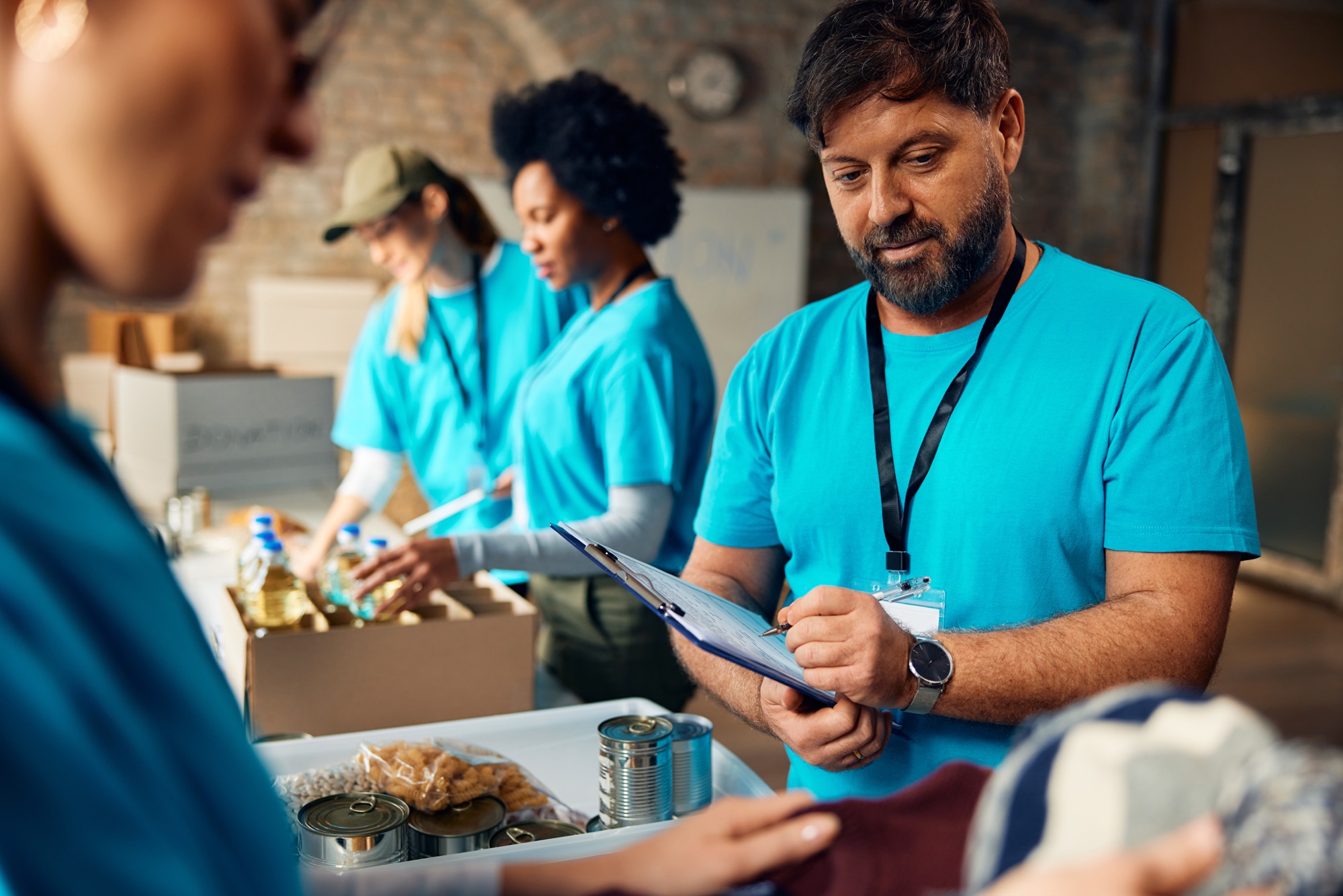 Volunteers organizing food and supply donations for community distribution